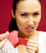 Woman ripping paper heart in half