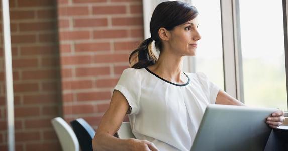 Don't use personal loan for credit card debt Woman seated with her laptop by the window | HeroImagesCLOSED/Getty Images