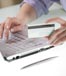woman typing holding credit card