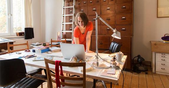 Should you use the simplified home office deduction? Woman working in home office | Simon Ritzmann/Getty Images
