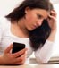 woman worried holding cellphone