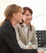 Two women and a man sitting at desk