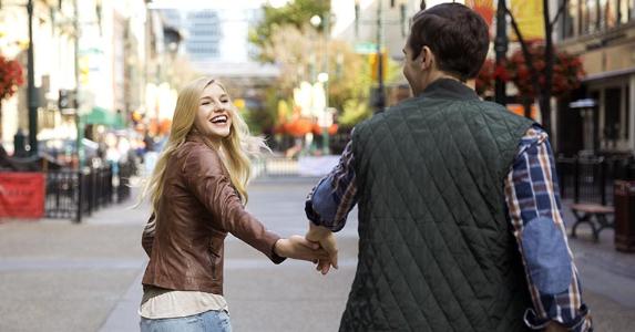 Make sure high-yield checking matches your needs Young couple holding hands walking in city | HeroImages/Getty Images