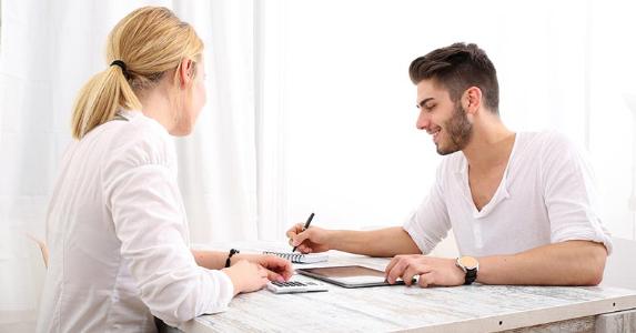 Young couple organizing their finances in white dining room © Spectral-Design/Shutterstock.com