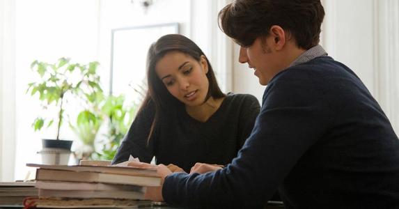 What a down payment on a home is Couple sitting together having a discussion | PhotoAlto/Sigrid Olsson/Getty Images
