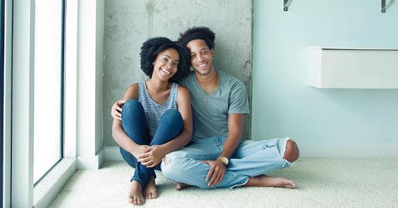 Deducting private mortgage insurance Young couple sitting on carpeted floor | Gary John Norman/DigitalVision/Getty Images