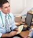 Young doctor billing older patient © Monkey Business Images/Shutterstock.com