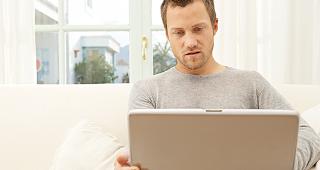 Man sitting with laptop © MJTH/Shutterstock.com