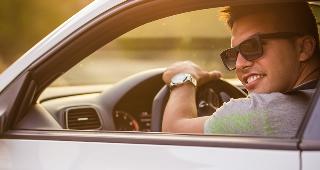 Young man driving car in sunset © Alexandros Halatsis/Shutterstock.com