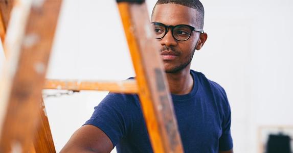 CD ladder: Is it worth the climb? Young man standing behind ladder | Westend61/Getty Images
