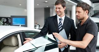 Car salesman in showroom Â© LifePhotoStudio/Shutterstock.com