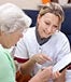 Young nurse old lady reviewing documents © Miriam Dörr / Fotolia