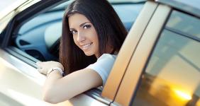 Young woman looking out of driver's side window © Nina Buday/Shutterstock.com