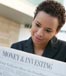 Young Woman Reading Investment Paper