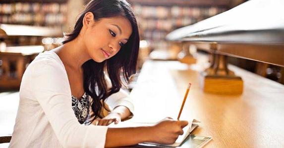 FAFSA secrets for scoring the most financial aid Young woman studying in library © arek_malang/Shutterstock.com